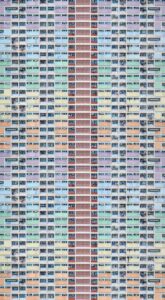 A colorful, modern residential building exterior in Hong Kong, emphasizing urban architecture.